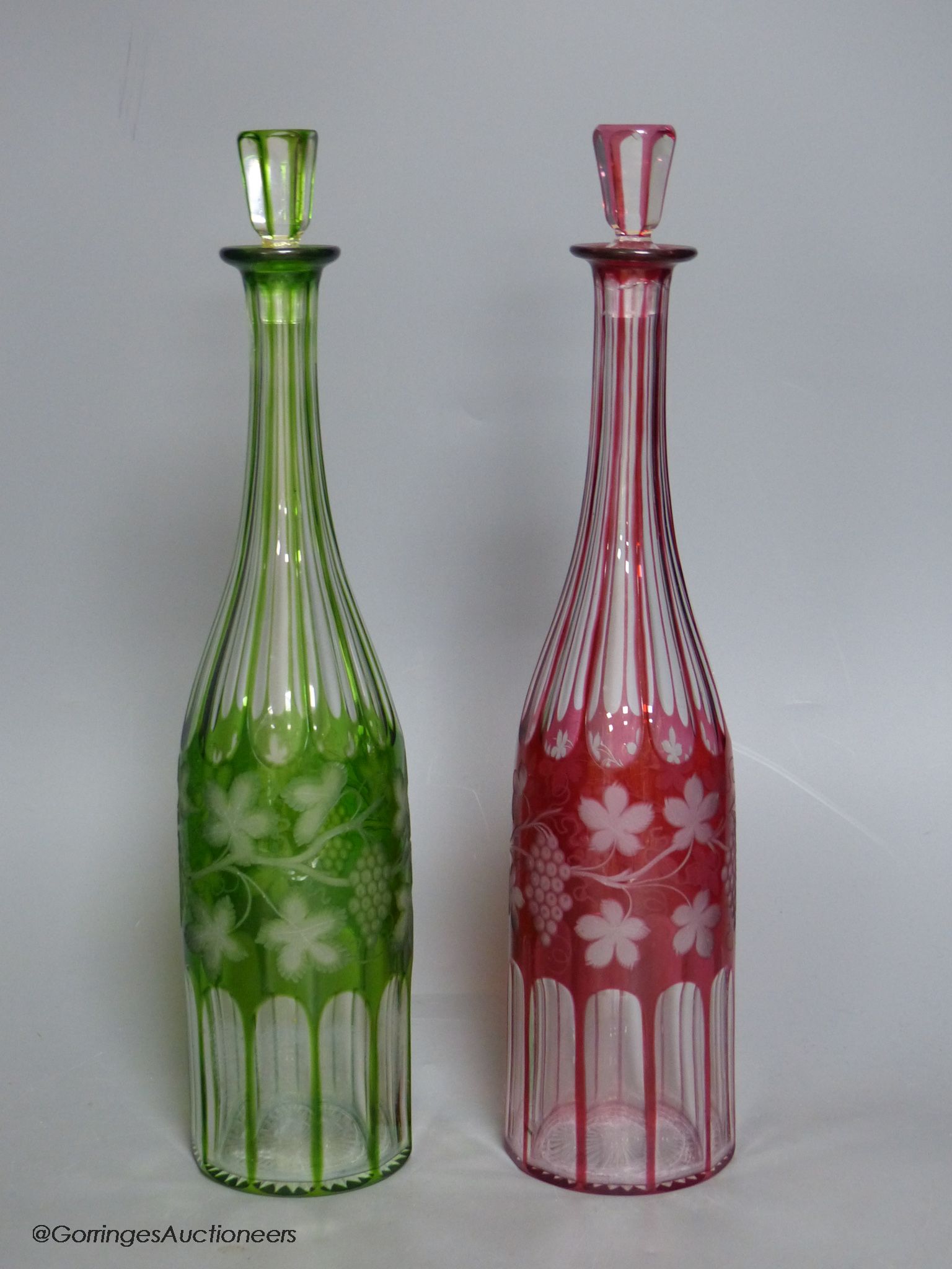 A pair of Bohemian colour flashed glass decanters